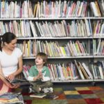 Elementary Student With Teacher in Library