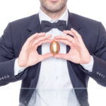 Businessman holding a golden egg for Easter