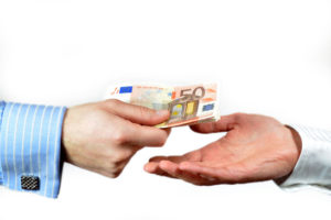 Male hand paying 50 euros to someone else, isolated on white